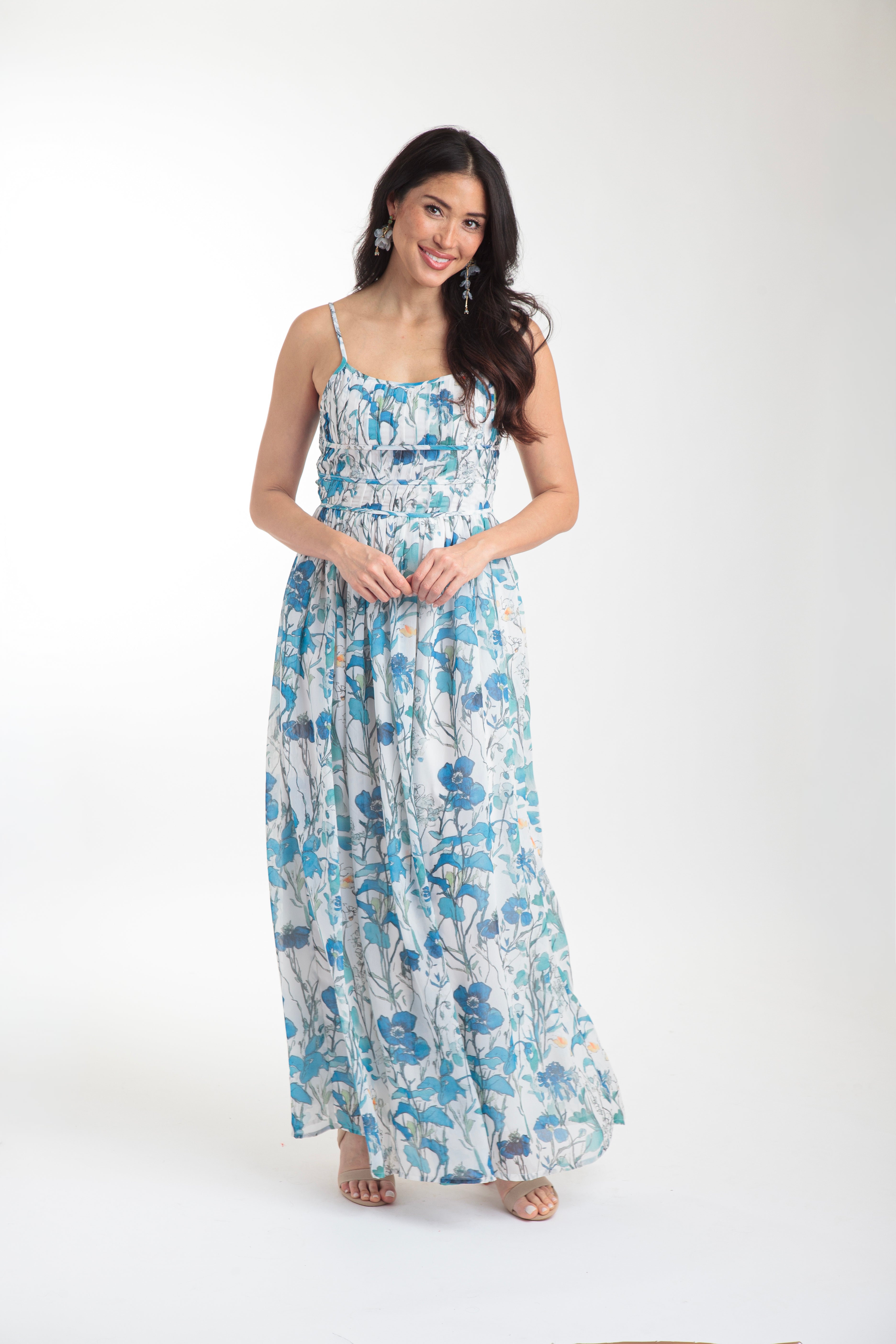 Woman wearing a blue floral dress on a white background